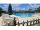 Community swimming pool with ample seating and a sunny atmosphere at 17809 Sandpine Trace Way, Tampa, FL 33647