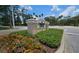 Community center sign with lush landscaping and colorful flowers at 17809 Sandpine Trace Way, Tampa, FL 33647