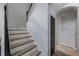 Elegant stairway with light wood treads and dark wood handrail, and white risers and stringers at 17809 Sandpine Trace Way, Tampa, FL 33647