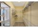 Spacious walk-in closet with extensive shelving and storage solutions and attached Primary bath at 17809 Sandpine Trace Way, Tampa, FL 33647