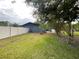 The backyard features an open lawn, a fire pit, and a white vinyl fence at 17933 Eagle Ln, Lutz, FL 33558