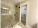 Bathroom with a tile shower and glass door adjacent to the toilet room at 17933 Eagle Ln, Lutz, FL 33558