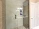 Bathroom featuring a glass shower, modern vanity, and door to another room at 17933 Eagle Ln, Lutz, FL 33558
