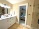 Well-lit bathroom boasts a double vanity, tile floors, and an open bedroom view at 17933 Eagle Ln, Lutz, FL 33558
