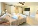 Bedroom featuring sliding barn doors, modern bedding, and neutral colors at 17933 Eagle Ln, Lutz, FL 33558