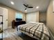 Comfortable bedroom features a ceiling fan, wood flooring, and a large desk with a window view at 17933 Eagle Ln, Lutz, FL 33558