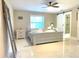 Well-lit bedroom featuring modern decor, tile flooring, and a sliding barn door at 17933 Eagle Ln, Lutz, FL 33558