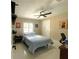 Cozy bedroom featuring a ceiling fan, shelving, window, and a closet at 17933 Eagle Ln, Lutz, FL 33558