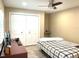 Cozy bedroom with a ceiling fan, closet and desk that offers ample storage space and functionality at 17933 Eagle Ln, Lutz, FL 33558