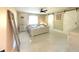 Bright bedroom featuring modern décor, tile flooring, and a sliding barn door at 17933 Eagle Ln, Lutz, FL 33558