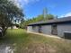 The exterior of the house showcases the well-maintained backyard, with a lawn and beautiful surroundings at 17933 Eagle Ln, Lutz, FL 33558