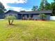 Inviting single-story home with lush landscaping, manicured lawn, and a fresh exterior at 17933 Eagle Ln, Lutz, FL 33558