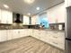 Modern kitchen featuring granite countertops, stainless appliances and wood-look tile at 17933 Eagle Ln, Lutz, FL 33558