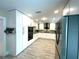 White kitchen featuring granite countertops, stainless appliances and wood-look tile at 17933 Eagle Ln, Lutz, FL 33558