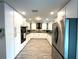 Bright kitchen with stainless steel appliances, wood-look tile and a large refrigerator at 17933 Eagle Ln, Lutz, FL 33558