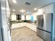 Modern kitchen with granite countertops, stainless appliances and wood-look tile flooring at 17933 Eagle Ln, Lutz, FL 33558