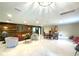 Spacious living room featuring a wood accent wall, a dining area, and an open layout at 17933 Eagle Ln, Lutz, FL 33558