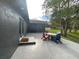 Back of house with gray patio and outdoor seating near sliding glass door entrance at 17933 Eagle Ln, Lutz, FL 33558
