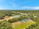 An aerial view showcases the community pool, tennis courts, sand volleyball and beautifully landscaped green spaces under a blue sky at 19156 Dove Creek Dr, Tampa, FL 33647