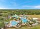 A community featuring swimming pools, a splash pad, tennis courts, and other amenities is captured in an aerial view at 19156 Dove Creek Dr, Tampa, FL 33647