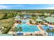 Aerial view of resort-style community pool featuring a lap pool, recreational area, lounge chairs, and covered seating areas at 19156 Dove Creek Dr, Tampa, FL 33647