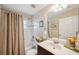 Bright bathroom featuring a shower-tub combo, vanity, and decor at 19156 Dove Creek Dr, Tampa, FL 33647