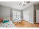 Cozy bedroom with a colorful bed, natural light, and a play table at 19156 Dove Creek Dr, Tampa, FL 33647