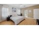 Bright bedroom features warm wood flooring, neutral walls, ceiling fan, and serene decor for restful retreat at 19156 Dove Creek Dr, Tampa, FL 33647
