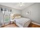 Bedroom featuring a cozy bed, side table, and a large window with natural light at 19156 Dove Creek Dr, Tampa, FL 33647