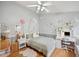 Charming bedroom with a stylish bed, a convenient desk, and wood flooring at 19156 Dove Creek Dr, Tampa, FL 33647