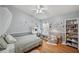 Bright bedroom featuring a desk, a cozy window seat, and modern decor at 19156 Dove Creek Dr, Tampa, FL 33647