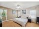 Bright bedroom features warm wood flooring, white walls, and serene decor for restful retreat at 19156 Dove Creek Dr, Tampa, FL 33647