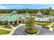 Stately community clubhouse with a lush green lawn and circular driveway enhanced with a tree in a flower bed at 19156 Dove Creek Dr, Tampa, FL 33647