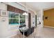 Dining area with glass table, large windows, and view of the screened-in pool and patio at 19156 Dove Creek Dr, Tampa, FL 33647