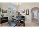 Open dining area featuring a large table, natural light, and views of the backyard through a large window at 19156 Dove Creek Dr, Tampa, FL 33647