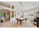 Spacious game room featuring a pool table, with views into other rooms at 19156 Dove Creek Dr, Tampa, FL 33647