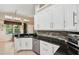 Bright kitchen features white cabinets, granite countertops, stainless steel appliances, and tiled backsplash at 19156 Dove Creek Dr, Tampa, FL 33647