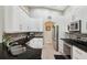 Bright kitchen features white cabinets, granite countertops, stainless steel appliances, and tiled backsplash at 19156 Dove Creek Dr, Tampa, FL 33647