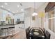 Modern kitchen with stainless steel appliances, granite countertops, and dining area at 19156 Dove Creek Dr, Tampa, FL 33647