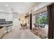 Open-plan living area with dining, kitchen, and lanai views, seamlessly blending indoor and outdoor spaces at 19156 Dove Creek Dr, Tampa, FL 33647