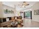 Inviting living room with sectional sofa, glass table, and lanai view blending indoor and outdoor spaces at 19156 Dove Creek Dr, Tampa, FL 33647