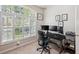 Well lit home office featuring large windows, a desk, and ample space for working at 19156 Dove Creek Dr, Tampa, FL 33647