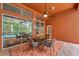 Cozy outdoor patio featuring a dining table, ceiling fan, and view of the screened pool, perfect for entertaining at 19156 Dove Creek Dr, Tampa, FL 33647