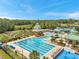 Resort-style pool area with lap lanes, water slide, splash pad, lounge chairs, and lush landscaping at 19156 Dove Creek Dr, Tampa, FL 33647
