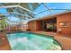 Sparkling in-ground pool with screened enclosure, adjacent to the home's patio and backyard landscaping at 19156 Dove Creek Dr, Tampa, FL 33647