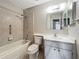 Bathroom featuring a tiled shower/tub combination, vanity and mirrored cabinet at 2014 Hampstead Cir, Sun City Center, FL 33573