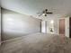 Spacious bedroom featuring neutral walls, plush carpeting, ceiling fan and access to a bathroom and closets at 2014 Hampstead Cir, Sun City Center, FL 33573