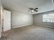 Bedroom with neutral carpet and walls, ceiling fan, and a bright window at 2014 Hampstead Cir, Sun City Center, FL 33573