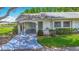 Charming villa featuring a covered carport and lush landscaping at 2014 Hampstead Cir, Sun City Center, FL 33573