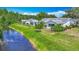 Beautiful single-story home boasting lush landscaping and a serene canal view at 2014 Hampstead Cir, Sun City Center, FL 33573